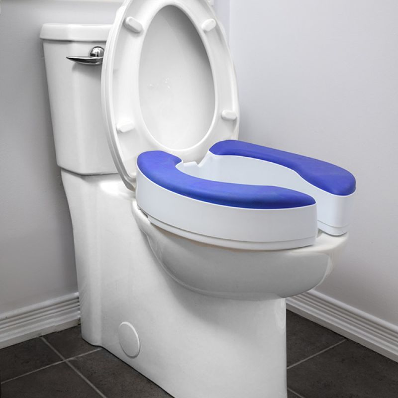A raised toilet seat with blue padding and handles enhances bathroom safety.