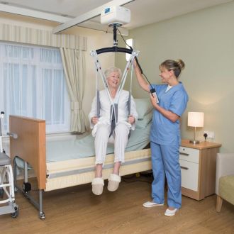 A nurse uses a patient lift system to help a senior, providing mobility and care solutions from a trusted medical supplier.